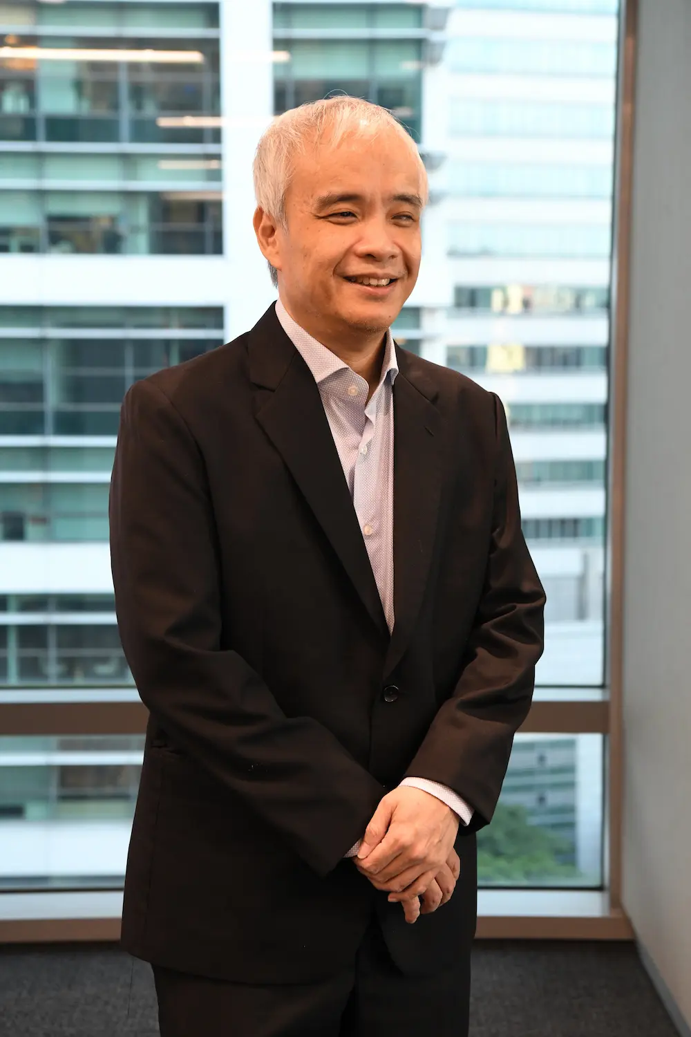 Mr Andrew Chew, K9Assistance Chairman, in a black suit.