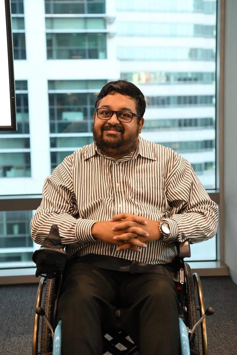 Dr Navin Nair, K9Assistance Director, in a striped shirt.