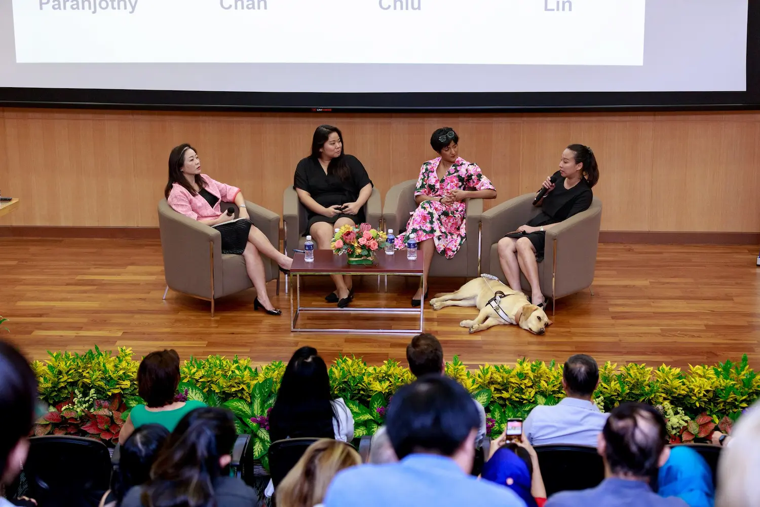 K9 Assistance Executive Director speaking, as part of a panelist of women, at an event